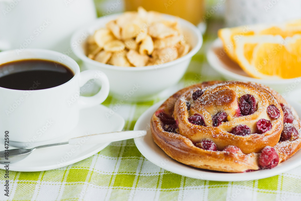Cup of coffee, baking, muesli and orange