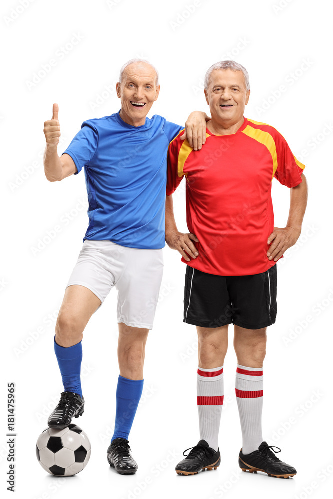 Two elderly soccer players with one of them making a thumb up gesture Two elderly soccer players with one of them making a thumb up gesture
