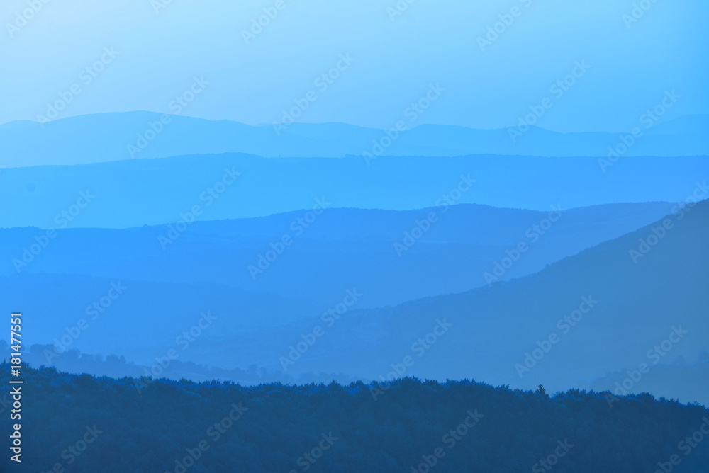Blue shades on mountains at the horizon in cold late autumn at sunrise