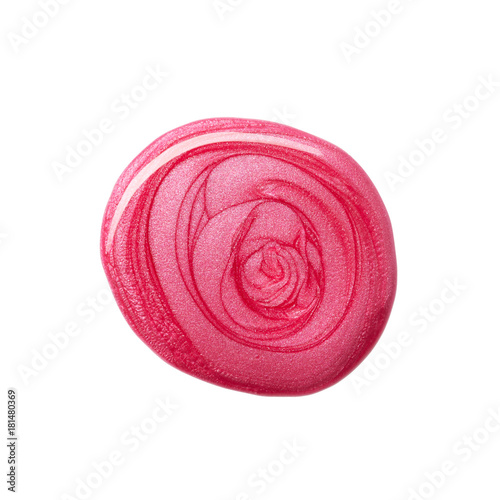 Round blot of pink nail polish isolated on white background photo