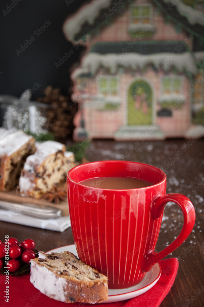 Sliced Christmas Stollen. Traditional german christmas cake with dried fruits and icing сигар with red coffee mug 