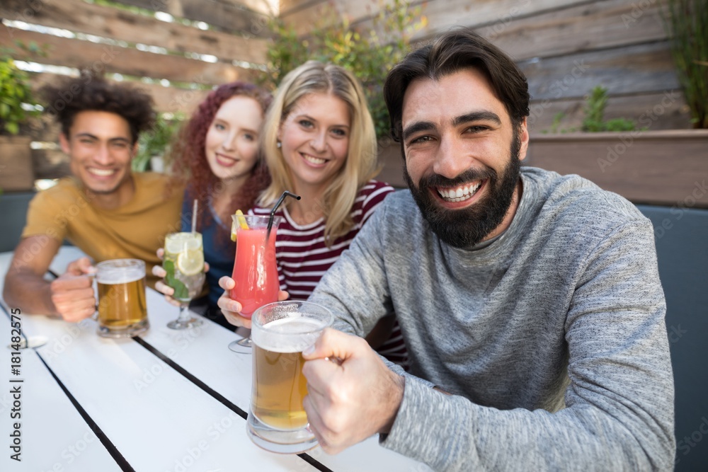 Fototapeta premium Friends holding glass of drinks in bar