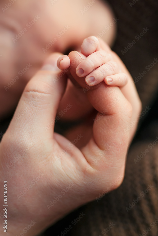 handle of infant and mother parent