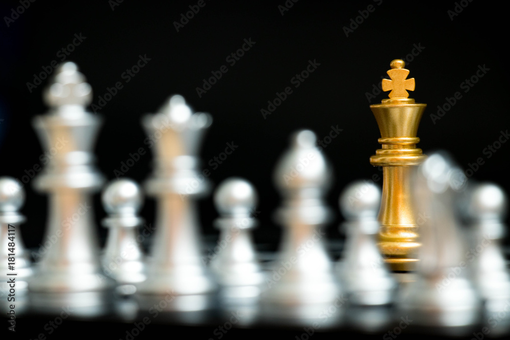 Gold king in chess game face with the another silver team on black background (Concept for company strategy, business victory or decision) Gold king in chess game face with the another silver team on black background (Concept for company strategy, business victory or decision)