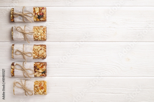 Homemade gluten free granola bars on wooden background. 