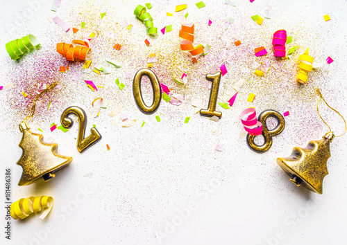 2018 new year background with confetti, sparkles, serpentine on white. Top view, close-up. Festive greeting card with copy spase.