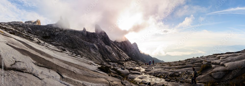 Climbers trek down the rocky slopes of Mount Kinabalu at sunrise, in Borneo, Malaysia.
