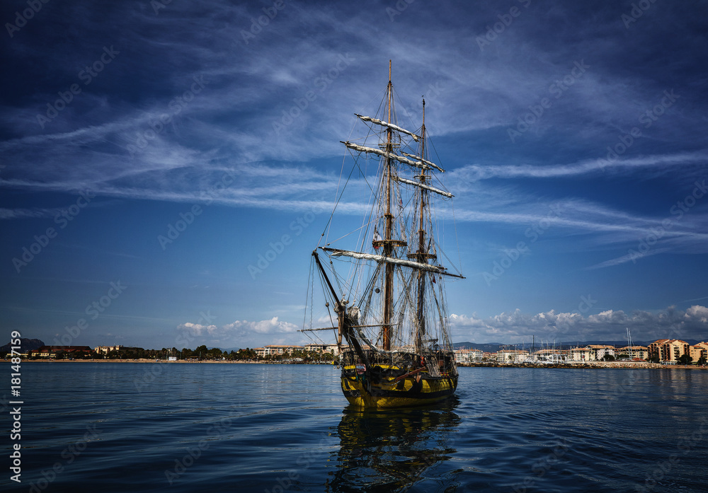 Old wooden sailing ship in the sea on summer day