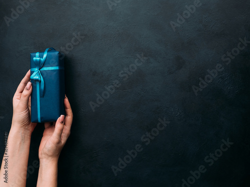 expensive luxury present for rich men on dark background. professional gift wrapping. worthy surprise for bithday, fathers day, valentines day, new year, christmas, thanksgiving and other holidays.