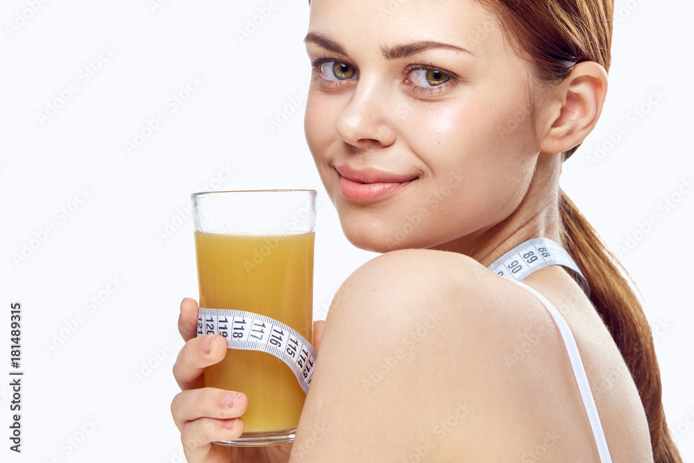 Beautiful young woman on white isolated background holds juice, health, diet, fitness Beautiful young woman on white isolated background holds juice, health, diet, fitness