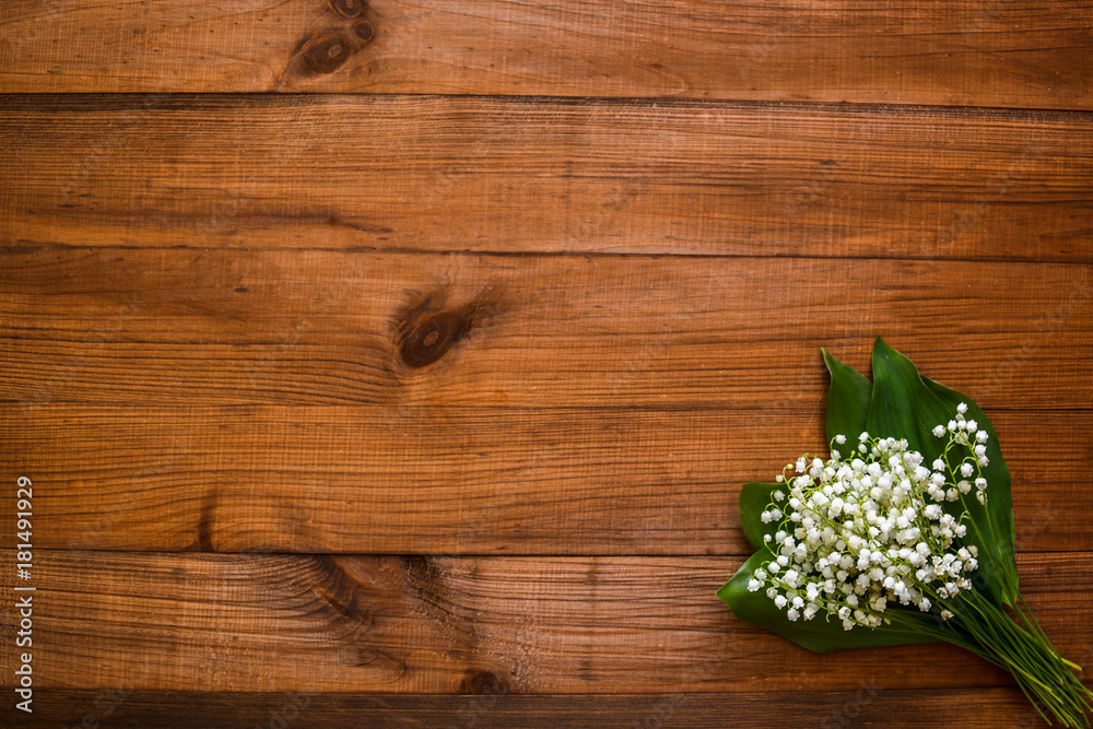 Lilies of the valley on a wooden old background and free space for your text. Lilies of the valley on a wooden old background and free space for your text.