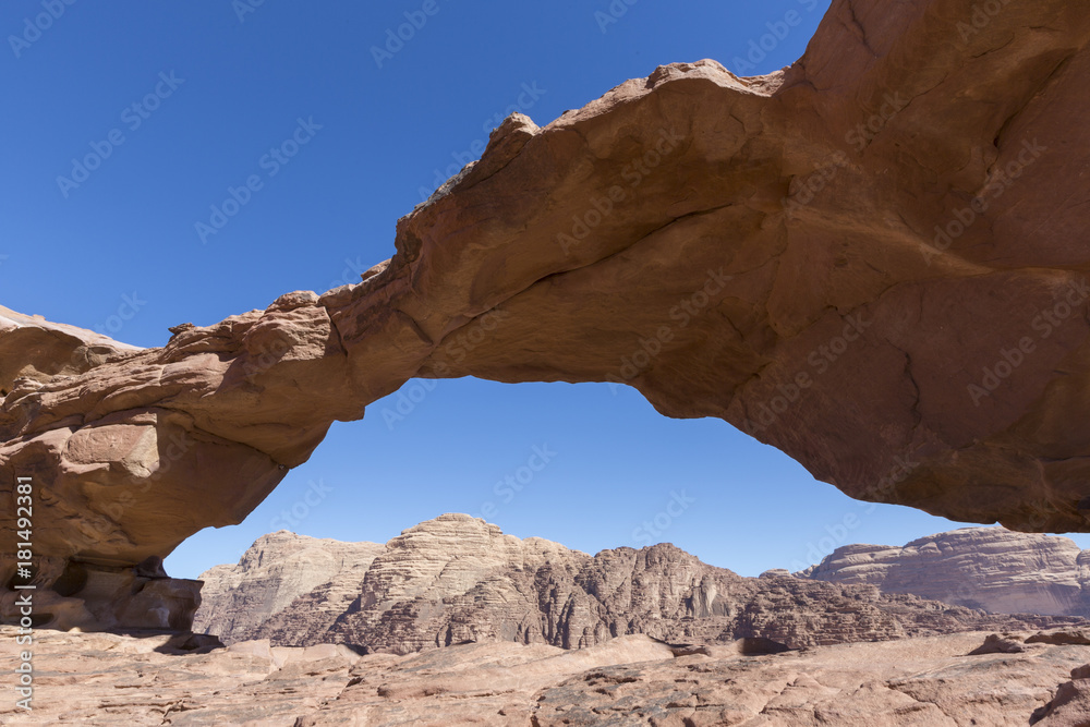 natural rock bridge and panoramic view of Wadi Rum desert, Jordan