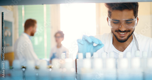 Male student of chemistry working in laboratory photo
