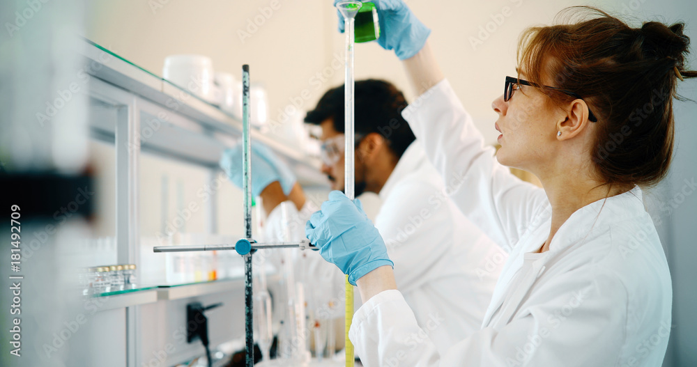 Young students of chemistry working in laboratory Young students of chemistry working in laboratory