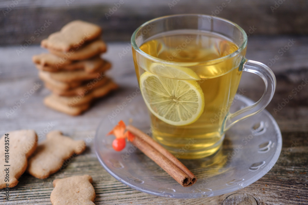green tea with lemon, ginger biscuits at the little animals on the table green tea with lemon, ginger biscuits at the little animals on the table