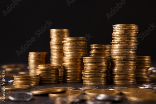 Several columns of gold coins on table