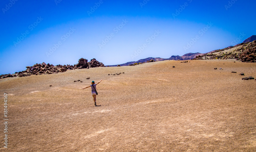 Girl enjoying freedom on the middle of the desert