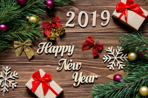Happy New Year 2019. Gifts and christmas tinsel on the wooden background
