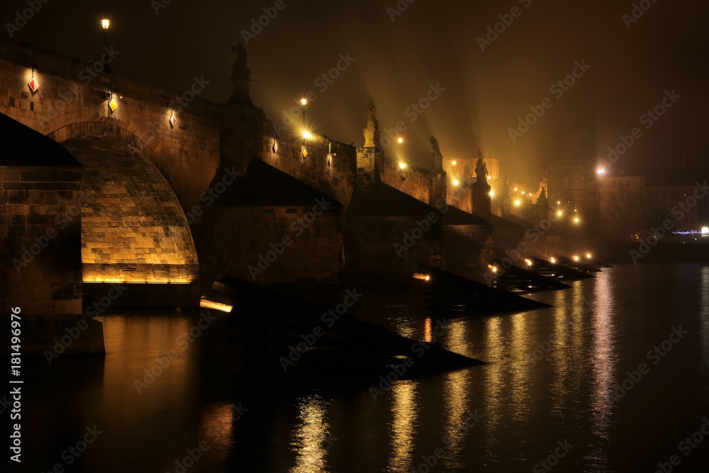 illuminated Charles Bridge (Karlův most) in the mist, Czech Republic