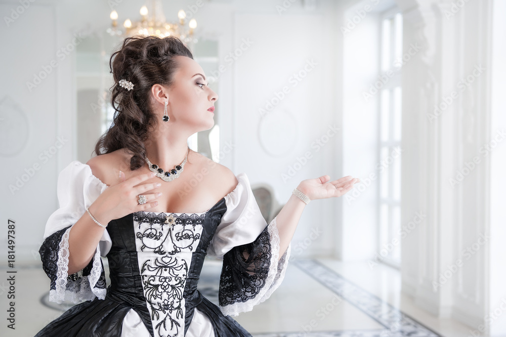 Beautiful young woman in long medieval dress