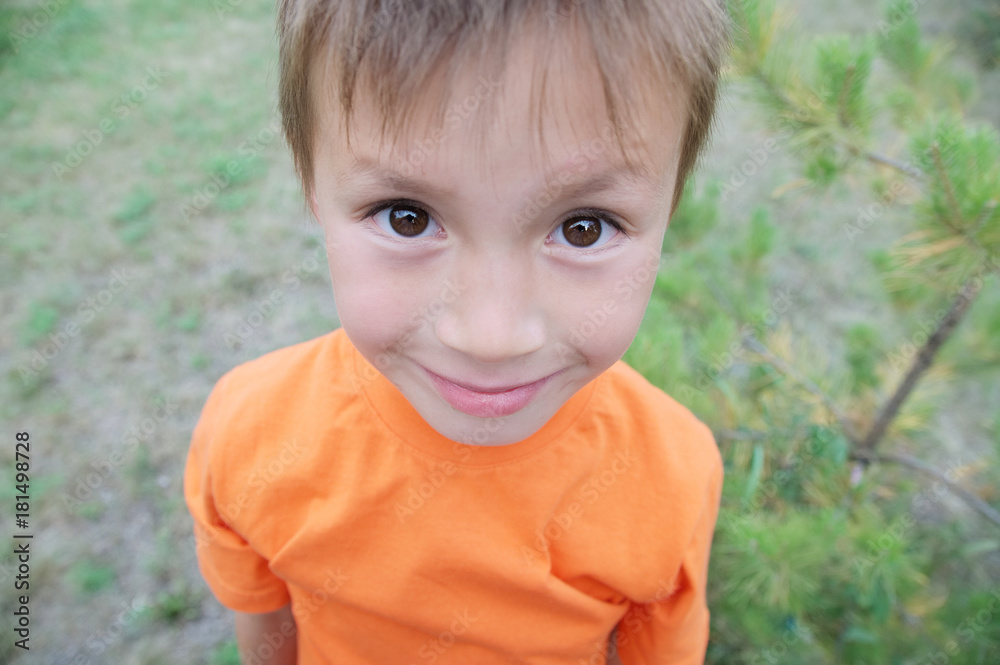 Little boy with big eyes smiling portrait from above Little boy with big eyes smiling portrait from above