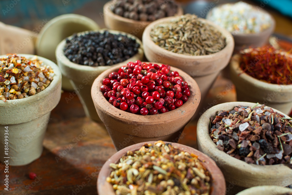 Fototapeta premium Variety of different asian and middle east spices, colorful assortment, on old wooden table