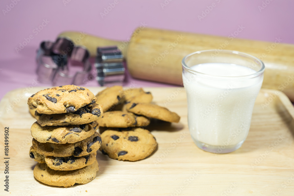 MILK GLASS AND CRACKERS A glass of milk with pile of crackers on the wood top table. MILK GLASS AND CRACKERS A glass of milk with pile of crackers on the wood top table.