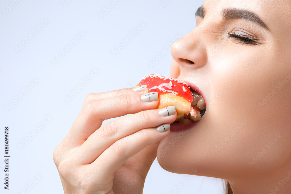 beautiful woman biting a donut beautiful woman biting a donut