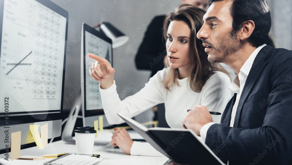 Concept of business team at working process.Young professionals work with new market project. Project managers meeting.Blurred background.Horizontal.Cropped. Concept of business team at working process.Young professionals work with new market project. Project managers meeting.Blurred background.Horizontal.Cropped.