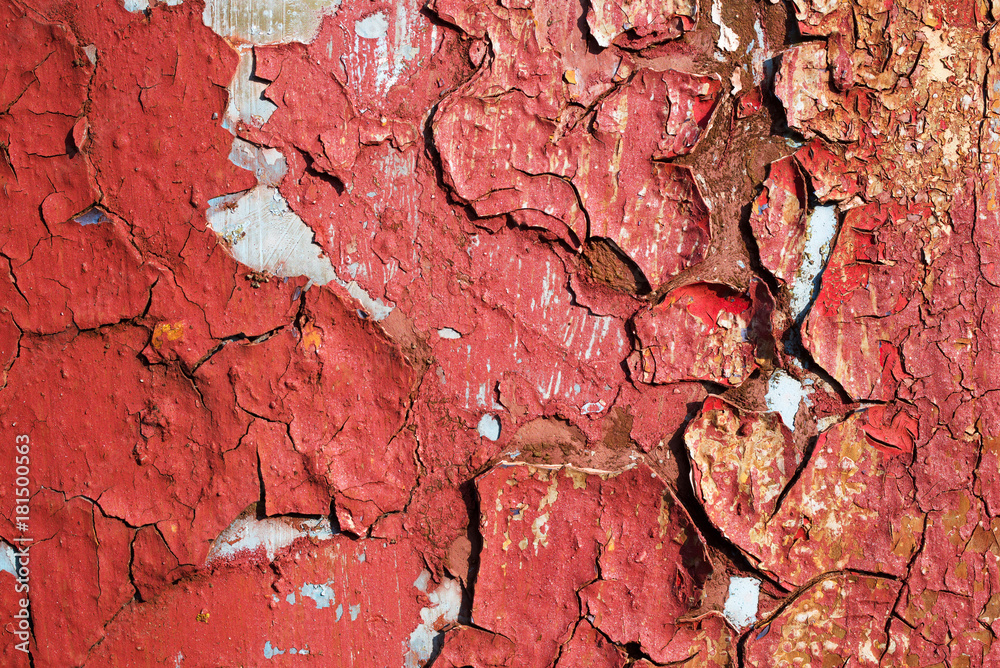 Rusty grunge background. Rusty old metal wall with the peeled red paint 