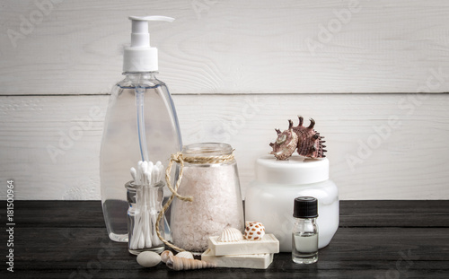 Spa beauty cosmetic products on white and black wooden background. Copyspace