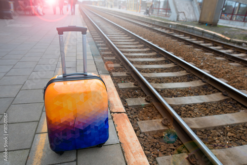 Colorful luggage near the railroad. Railway station. Ready to travel.