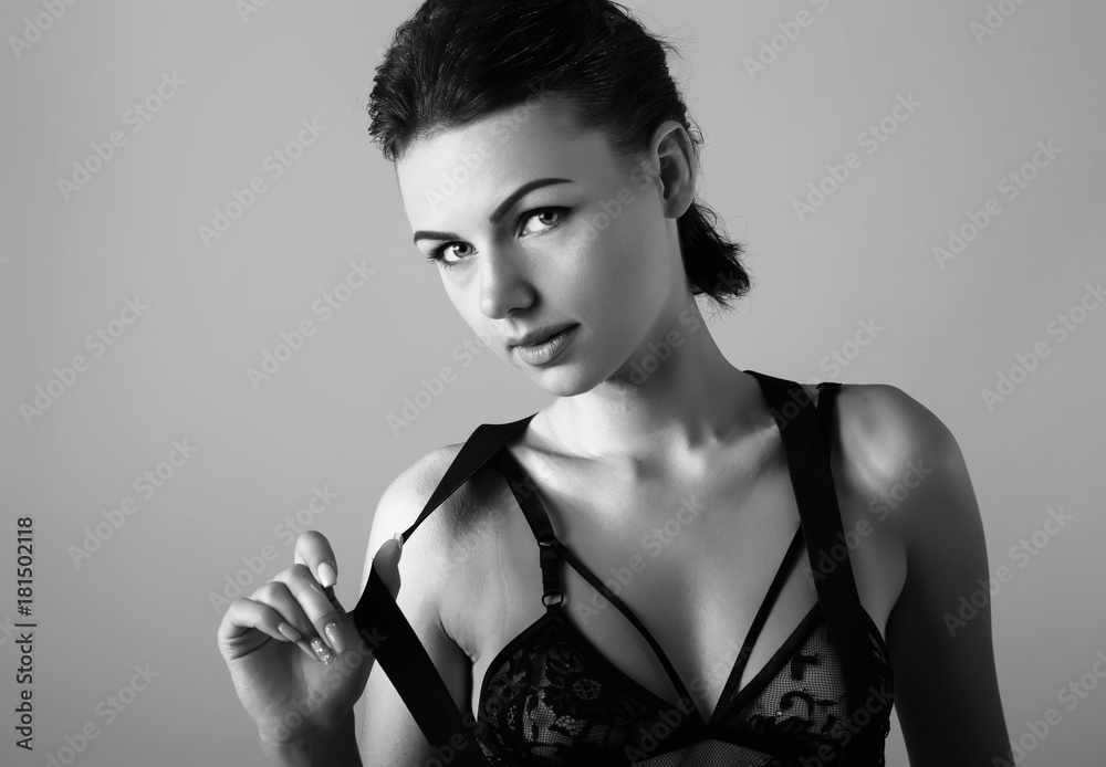 Black-white portrait of beautiful young sexygirl in underwear.Beautiful  woman with short brown hair. Closeup portrait of a fashion model posing at  studio, wearing bra and make up Stock Photo