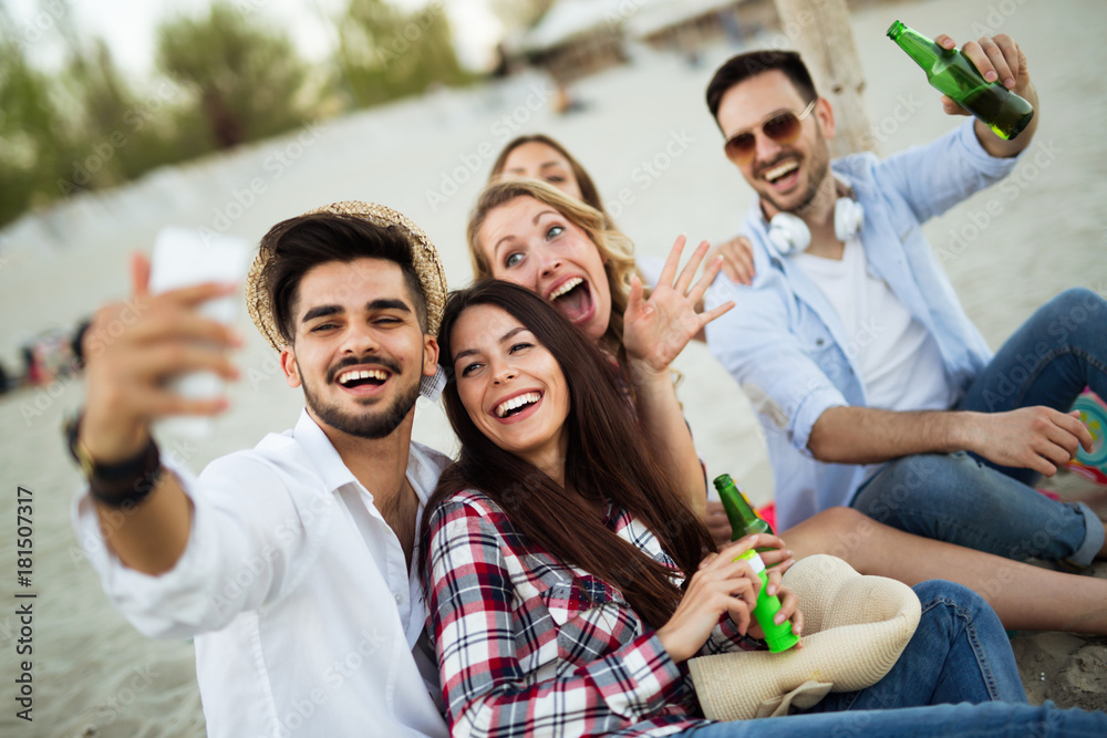 Happy young group of people taking selfies on beach Happy young group of people taking selfies on beach