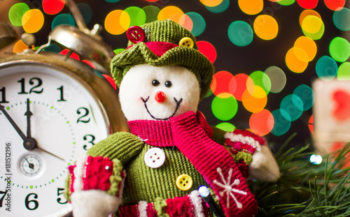 Toy snowman against festive background