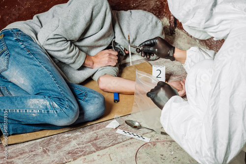 Criminological expert collecting evidence at the crime scene.