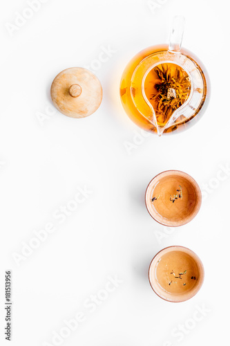 Tea ceremony concept. Tea pot, cups or bowls on white background top view copyspace