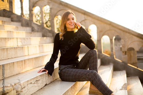 Young woman holding mobile ...