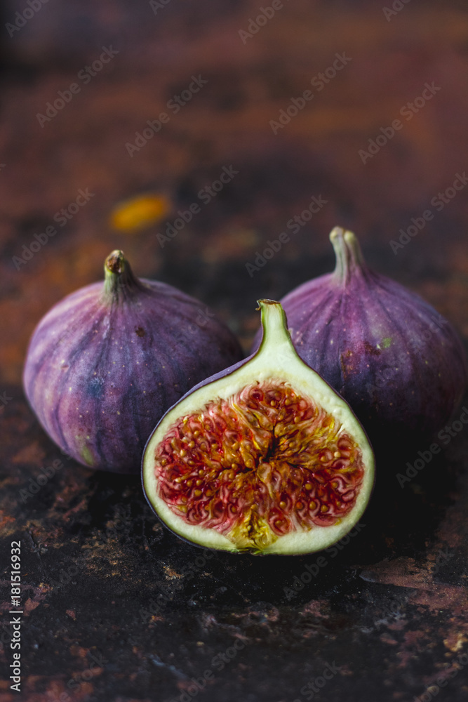 Half of fresh ripe figs on rusty metal surface. Half of fresh ripe figs on rusty metal surface.