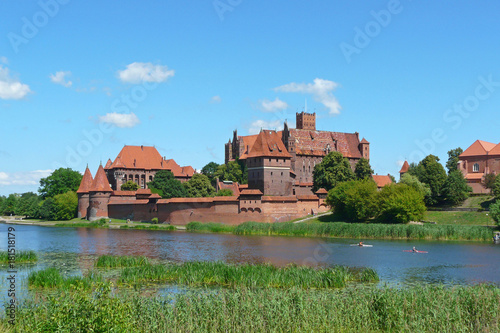 The Marienburg in Malbork from the west riverbank of the Nogat river in Poland, the world largest brick castle