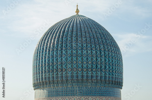 The top of the dome with tiles and mosaics in ancient Asian style. the details of the architecture of medieval Central Asia