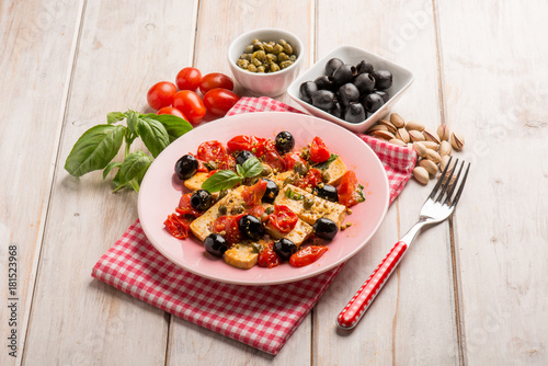 tofu salad with tomatoes black olives capers and pistachio