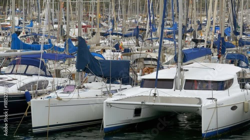 BARCELONA, SPAIN, SEPTEMBER 22, 2017: Parked Ships, Boats, Yachts in the Port Vell of Barcelona, Spain. Panoramic view of the ships parked in the port of Rambla del Mar. View of the pier from the photo