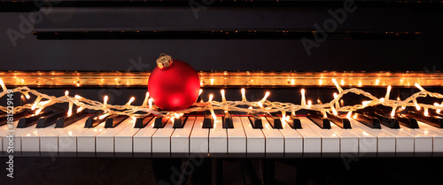 Photography Christmas ball and lights on a piano keyboard, front view