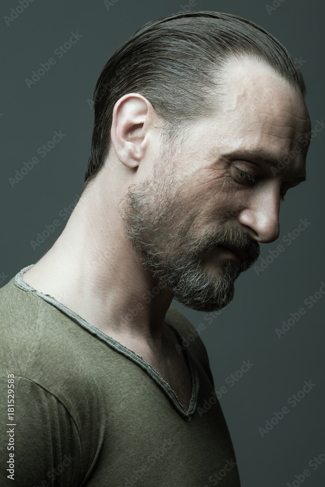 Male beauty concept. Fabulous at any age. Portrait of 40-year-old man  standing over dark gray background. Hair brushed back. Rocker, biker style.  Close up. Studio shot Stock Photo | Adobe Stock