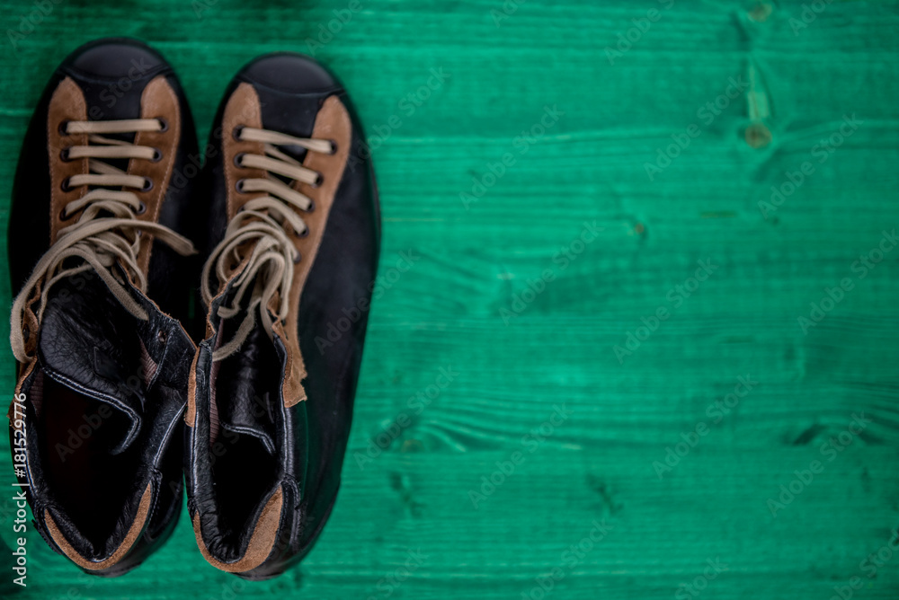 Top view of men's boots isolated on green background