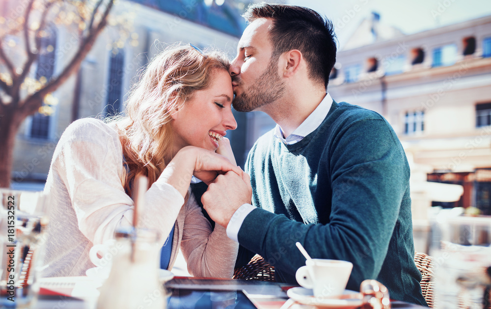 Romantic loving couple drinking coffee, having a date in the cafe. Dating, love, relationships