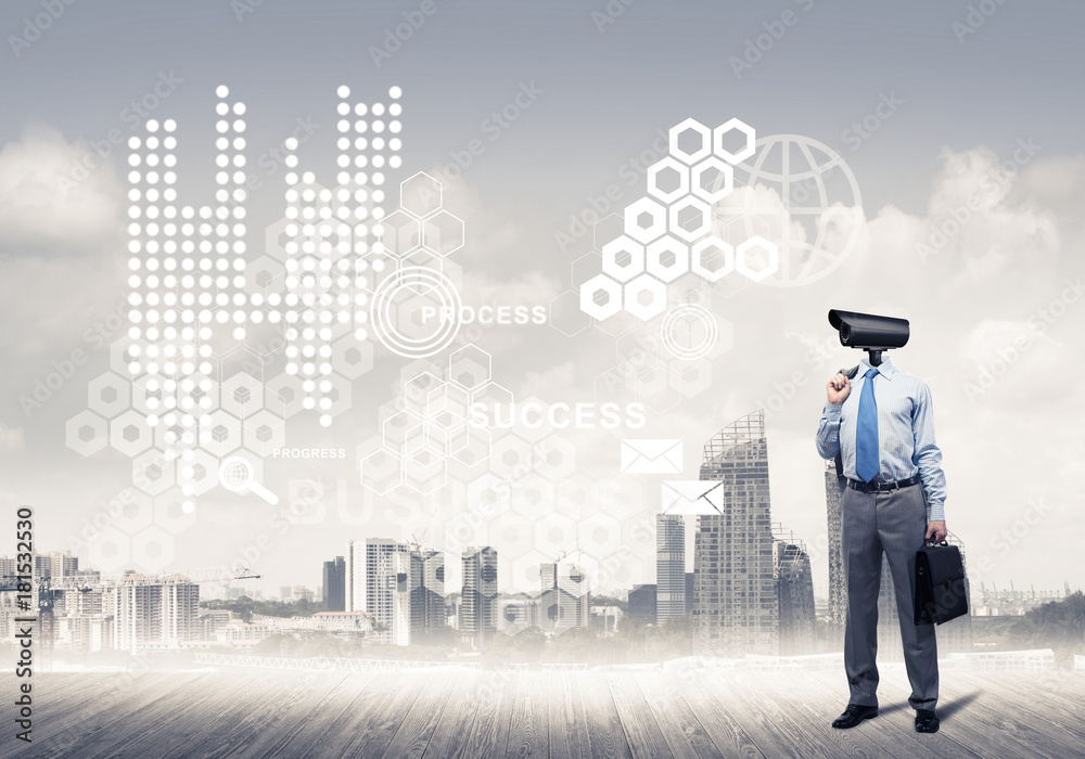 Camera headed man standing on wooden floor against modern citysc Camera headed man standing on wooden floor against modern citysc