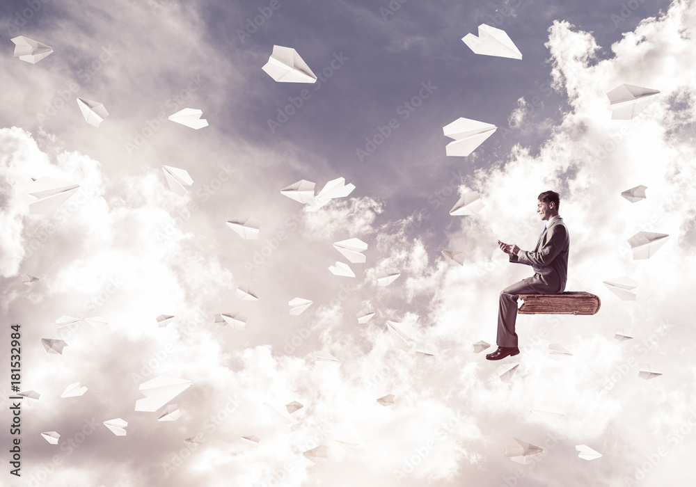 Businessman or student on book and paper planes flying around Businessman or student on book and paper planes flying around