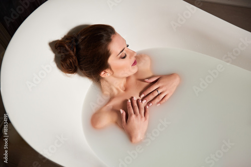 Woman in bath of milk